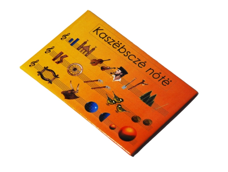 Magnes Kaszubskie Nuty z kolorowym wzorem przedstawiającym symbole kaszubskiej wyliczanki, na żółtym tle, na lodówce, pralce, zmywarce produkt regionalny