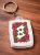Brelok_akrylowy_folk_design_prostoktny_podhale_haft_kwiaty_bialy.jpg