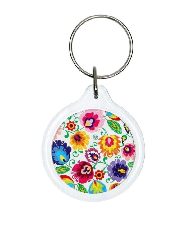 Okrągly_bialy_breloczek_z_motywem_lowickim_kwiaty_folk